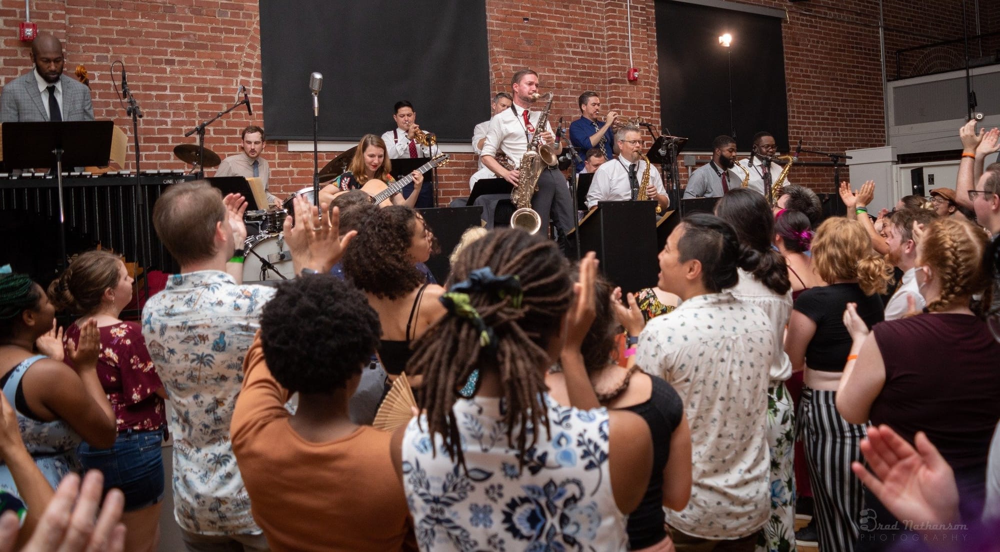 Archive photograph of musicians and dancers from the Flying Home official website